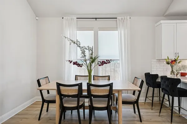 a view of a dining room with furniture and wooden floor