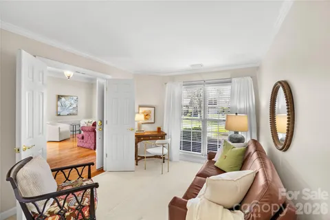 a living room with furniture a rug floor and a large window
