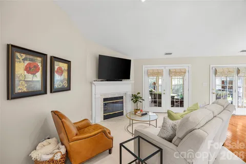 a living room with furniture fireplace and flat screen tv