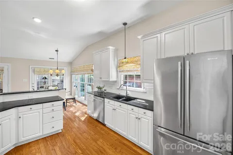 a kitchen with stainless steel appliances a refrigerator sink and stove
