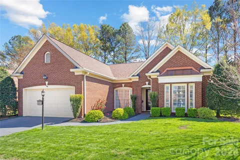 a front view of house with a garden