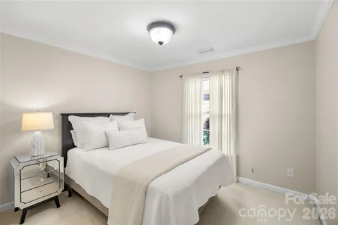 a bedroom with a bed and a night stand