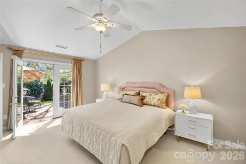 a bedroom with a large bed and a chandelier