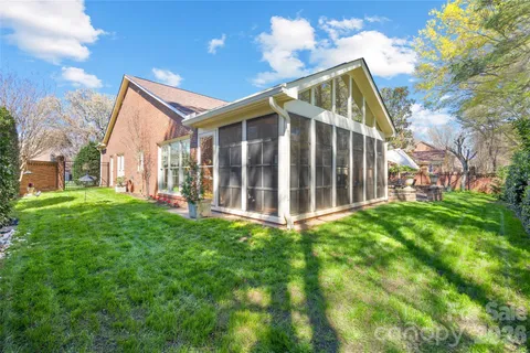 a view of backyard with deck and garden