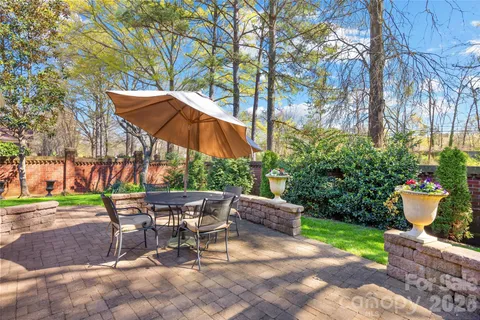 a view of outdoor dining space with a patio and fire pit