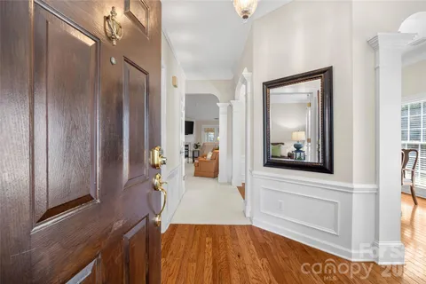 a view of a hallway view with wooden floor and staircase