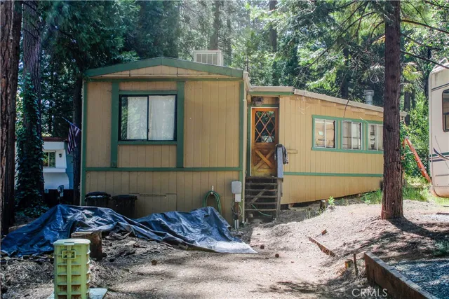 a front view of a house with trees