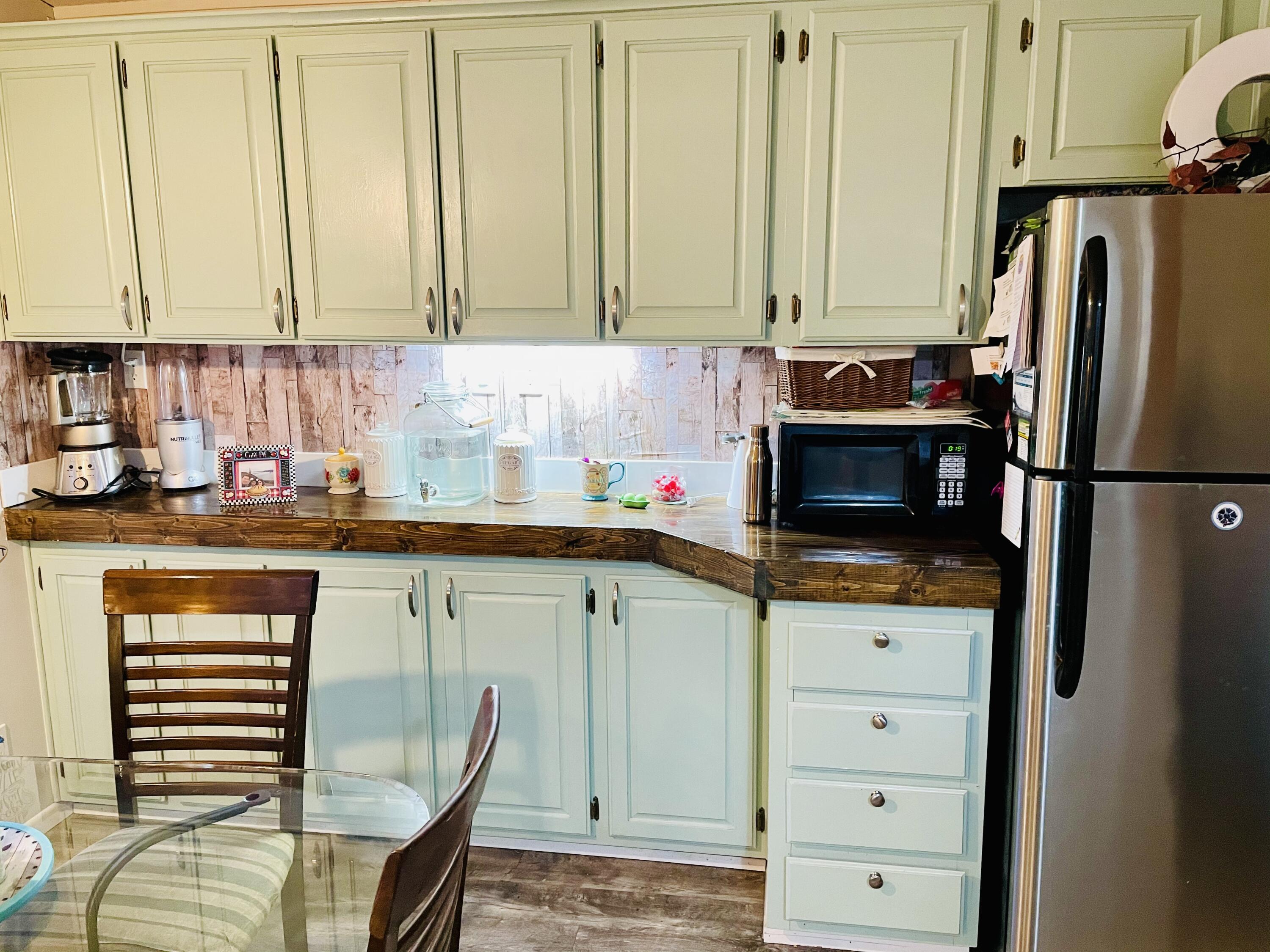 60901 Brosterhous Road, Unit 737 Bend, OR 97702 - Photo 7 of 17 a kitchen with stainless steel appliances a refrigerator stove and cabinets