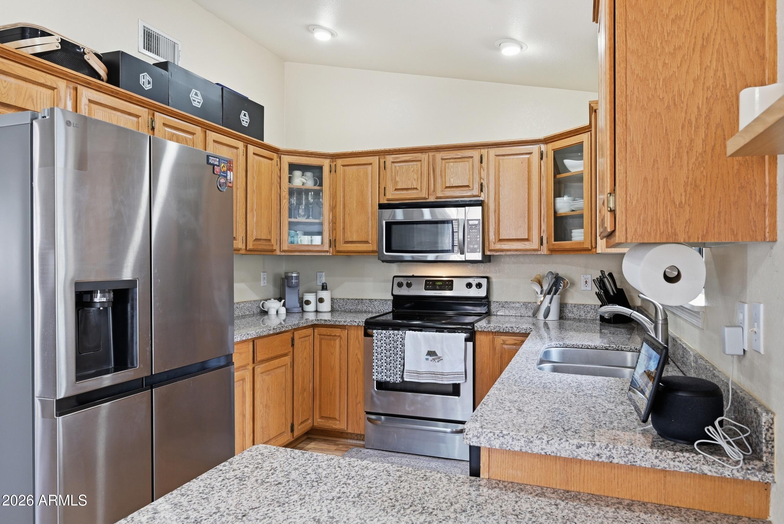 905 West Prairie Road Payson, AZ 85541 - Photo 13 of 38 a kitchen with stainless steel appliances granite countertop a refrigerator stove top oven and sink
