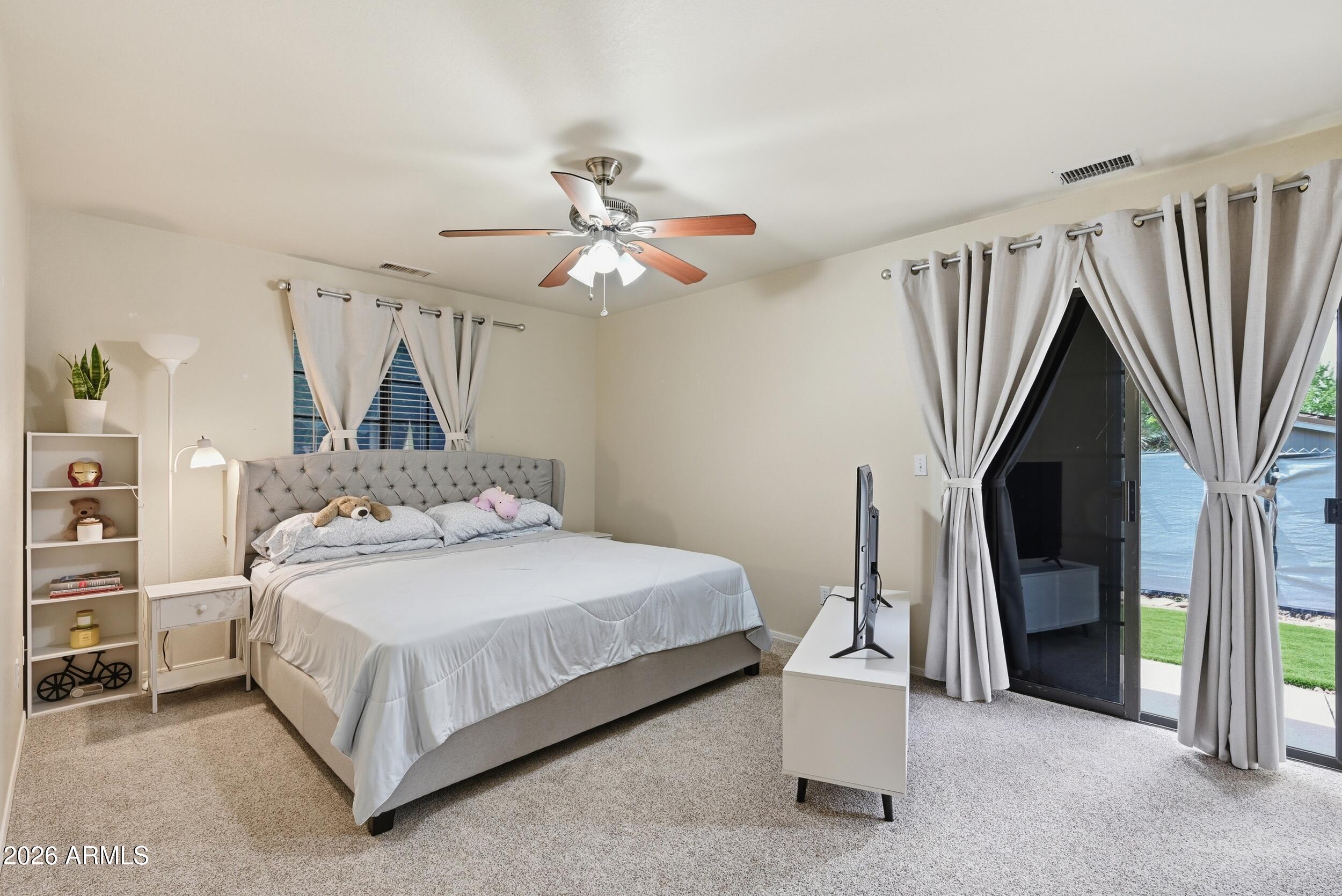 905 West Prairie Road Payson, AZ 85541 - Photo 16 of 38 a bedroom with a bed closet and a ceiling fan