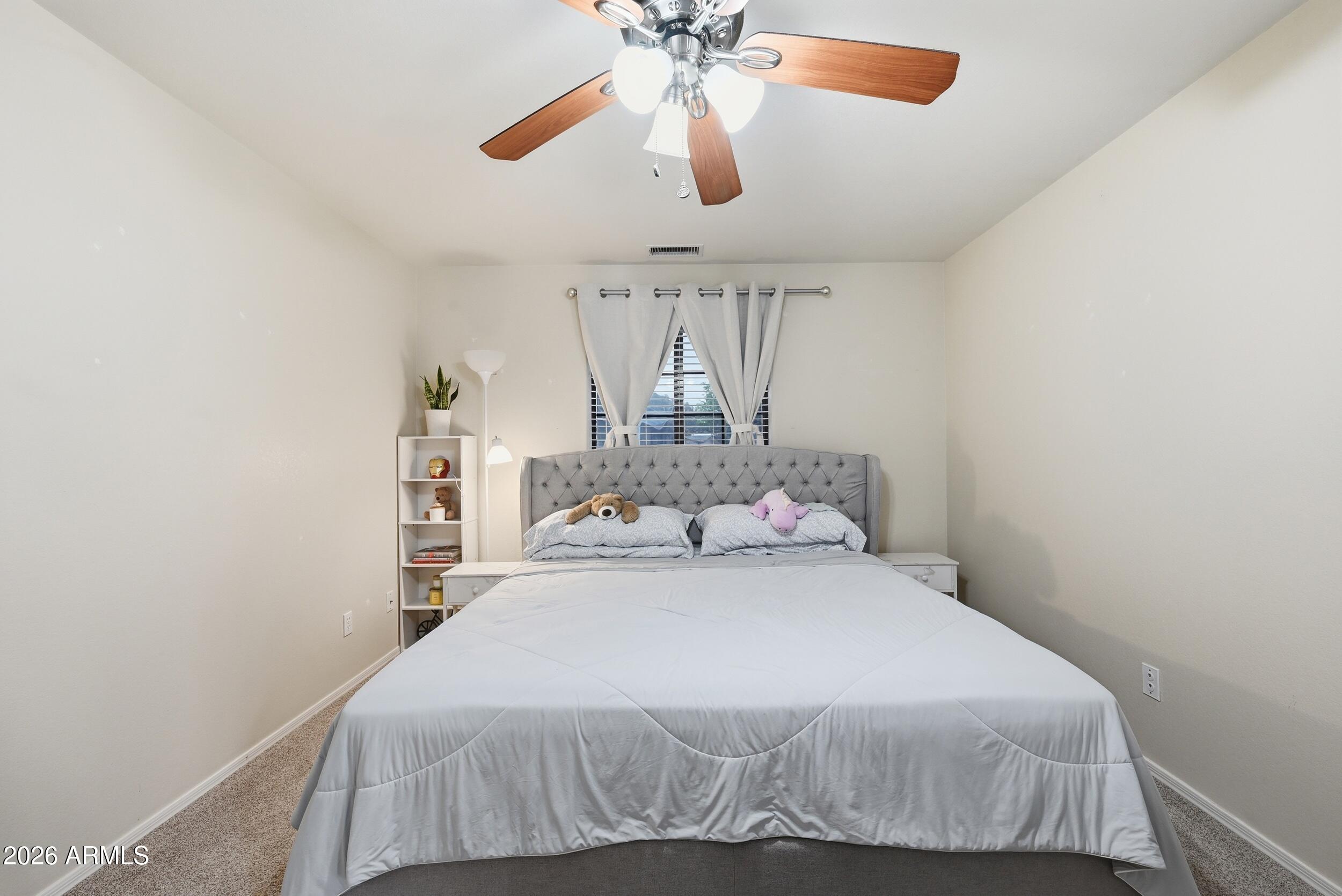 905 West Prairie Road Payson, AZ 85541 - Photo 17 of 38 a bedroom with a bed and a chandelier