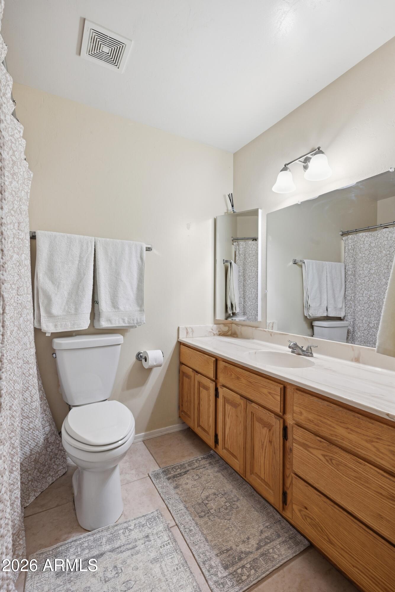 905 West Prairie Road Payson, AZ 85541 - Photo 19 of 38 a bathroom with a toilet sink and mirror