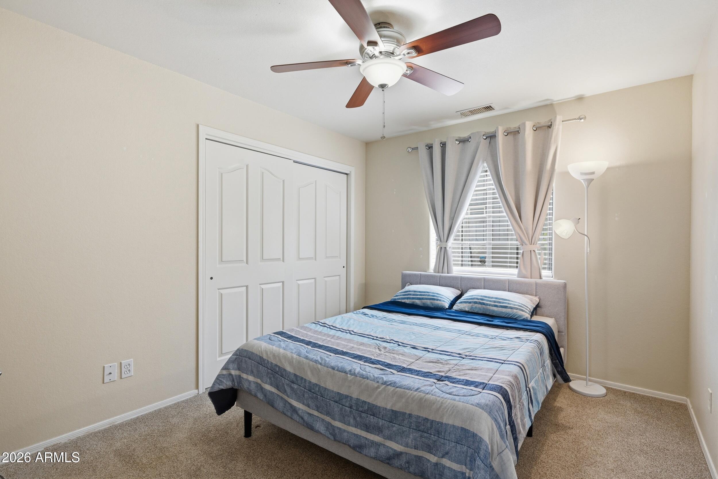 905 West Prairie Road Payson, AZ 85541 - Photo 21 of 38 a bedroom with a bed and a chandelier