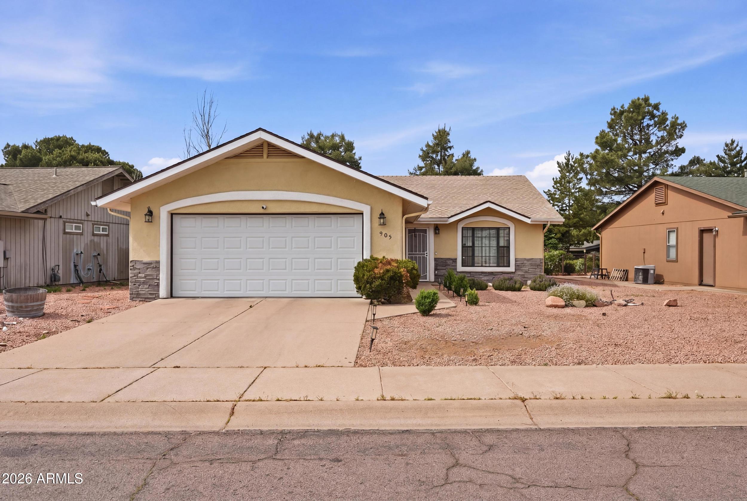 905 West Prairie Road Payson, AZ 85541 - Photo 3 of 38 a front view of a house with a yard and garage