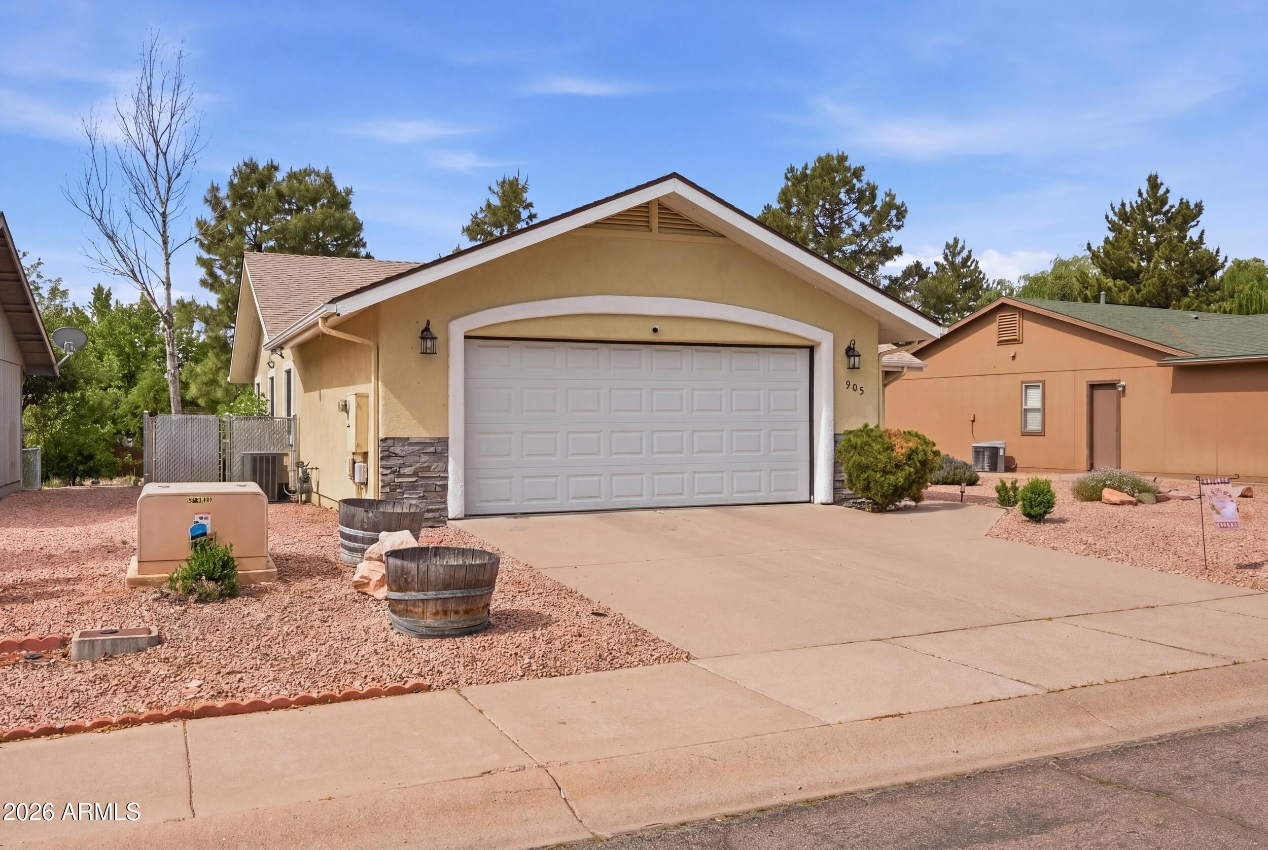 905 West Prairie Road Payson, AZ 85541 - Photo 4 of 38 a view of a house with a yard and potted plants