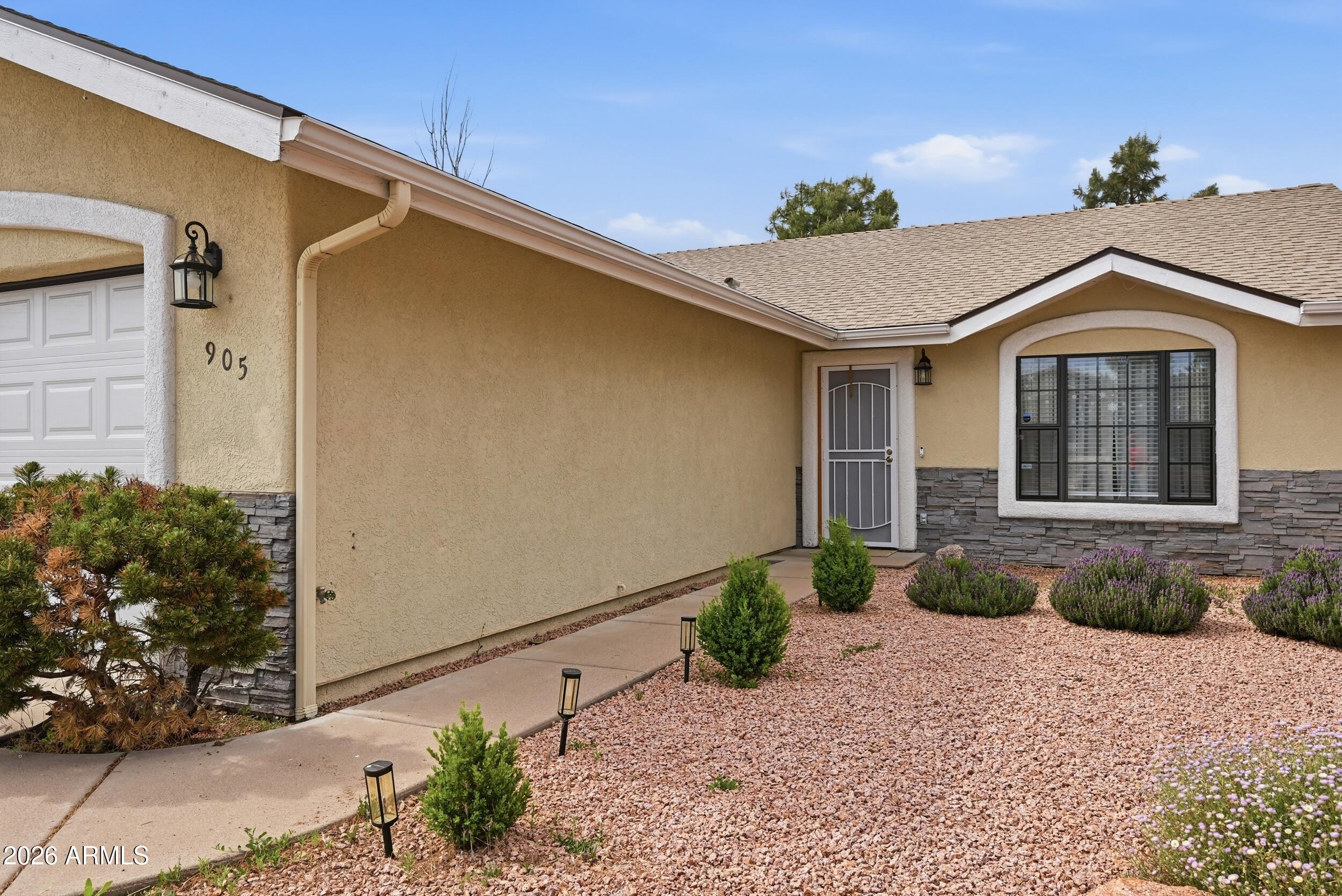 905 West Prairie Road Payson, AZ 85541 - Photo 5 of 38 a front view of a house with a yard