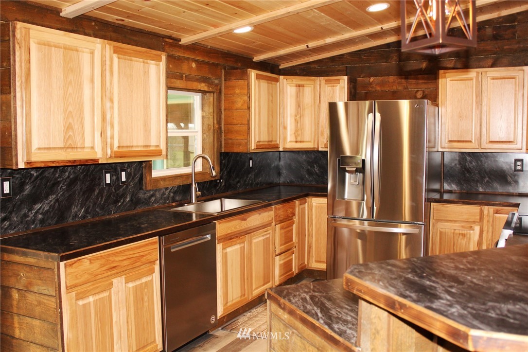 18337 Forstrom Street Southwest Rochester, WA 98579 - Photo 3 of 26 a kitchen with stainless steel appliances granite countertop a refrigerator and a sink
