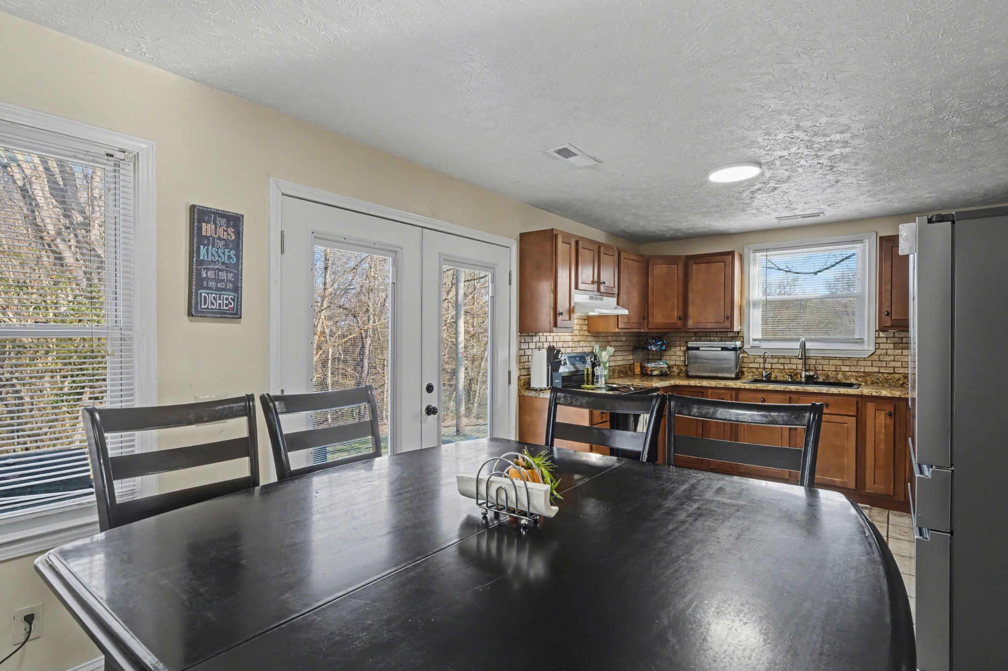 116 Tracy Academy Street Charlotte, TN 37036 - Photo 12 of 36 a kitchen with a table chairs and wooden floor
