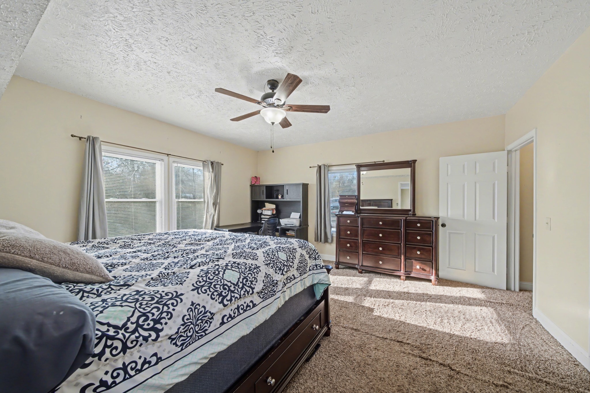 116 Tracy Academy Street Charlotte, TN 37036 - Photo 15 of 36 a bedroom with a large bed and a chandelier