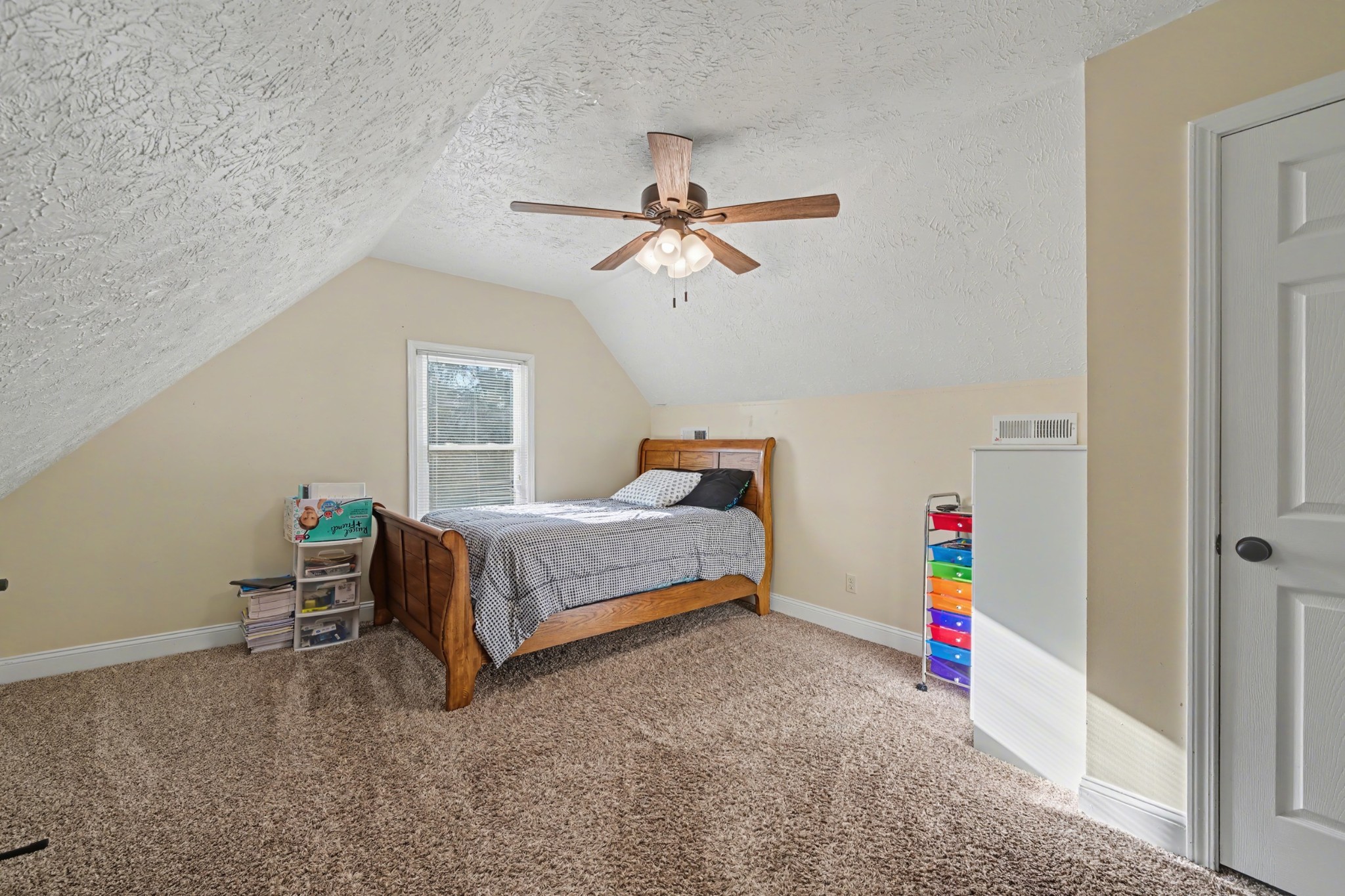 116 Tracy Academy Street Charlotte, TN 37036 - Photo 24 of 36 a bedroom with a bed and a chandelier