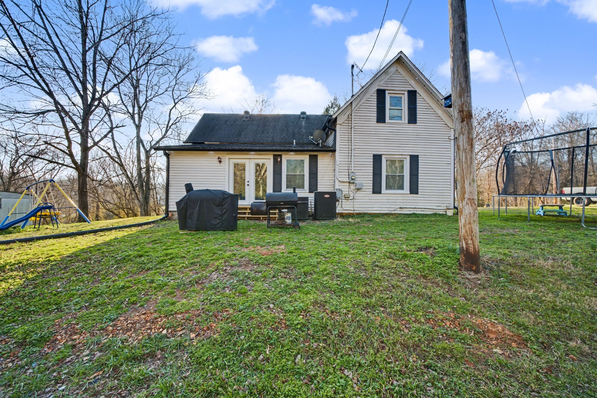116 Tracy Academy Street Charlotte, TN 37036 - Photo 27 of 36 a front view of a house with a yard and trees