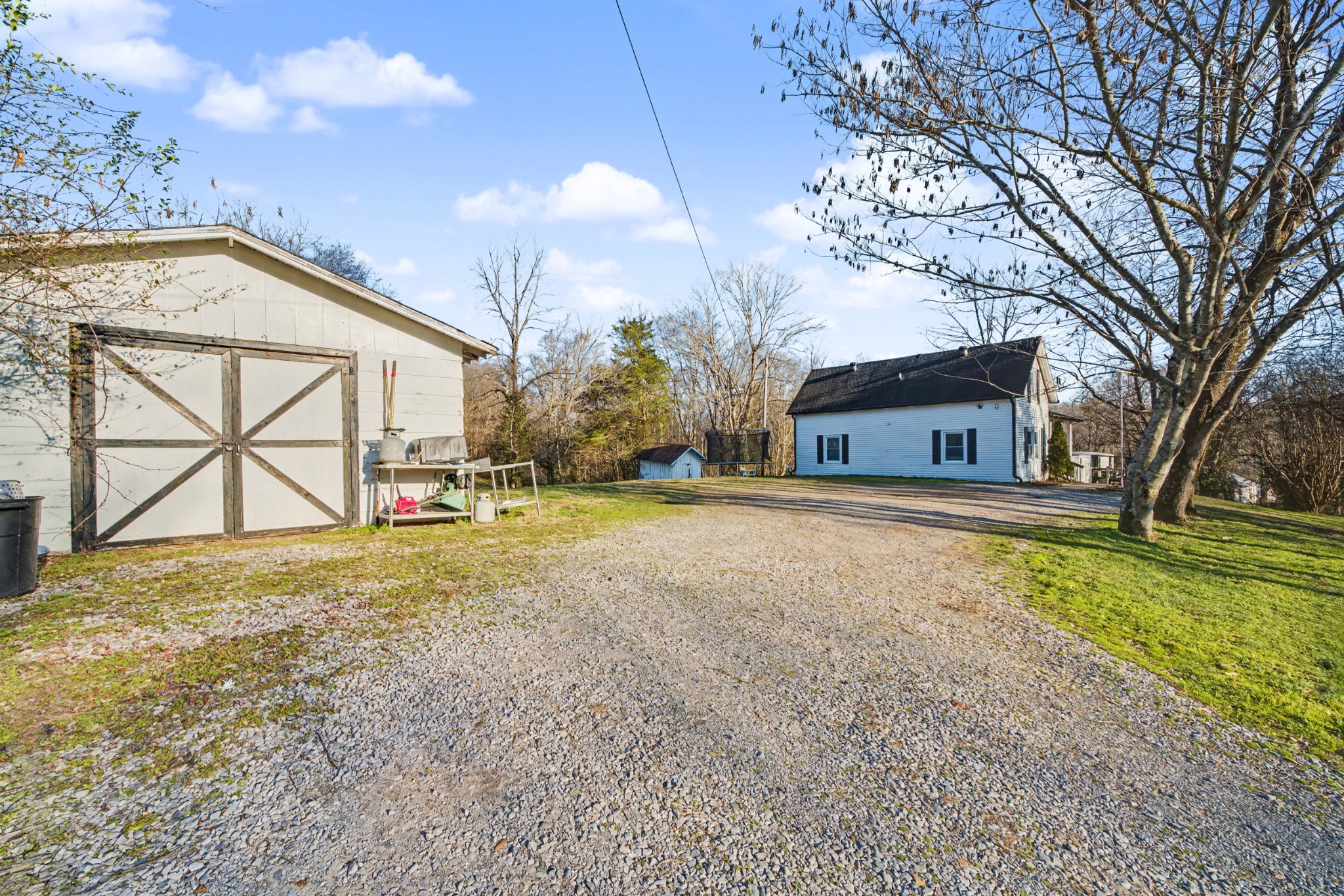 116 Tracy Academy Street Charlotte, TN 37036 - Photo 29 of 36 a house with trees in front of it