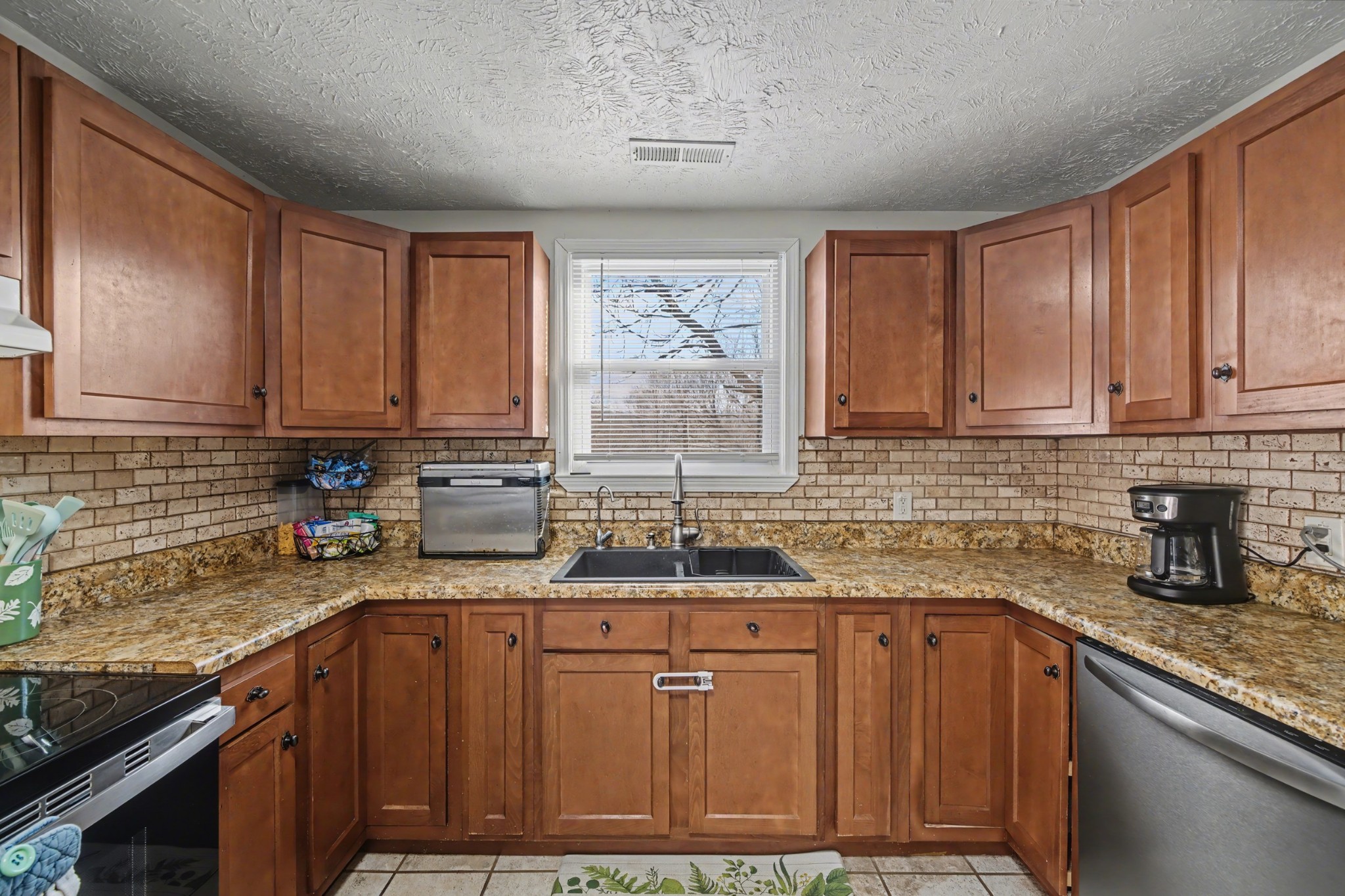 116 Tracy Academy Street Charlotte, TN 37036 - Photo 9 of 36 a kitchen with stainless steel appliances granite countertop a sink stove and cabinets