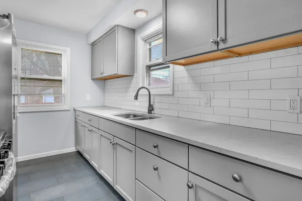 a kitchen with a sink and cabinets