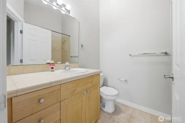 a bathroom with a sink a toilet and a mirror