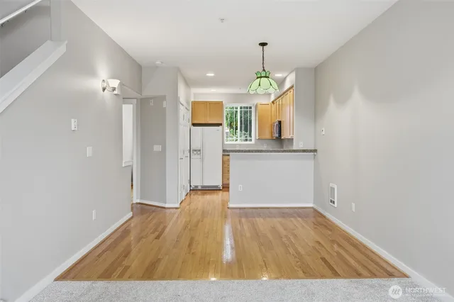 a view of a kitchen with a sink and wooden floor