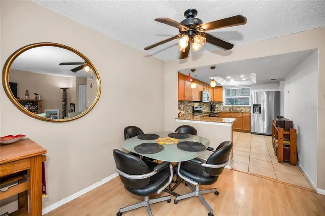a living room with furniture a window entryway and wooden floor