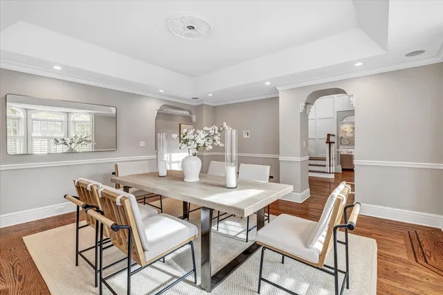 a view of a livingroom with wooden floor and staircase