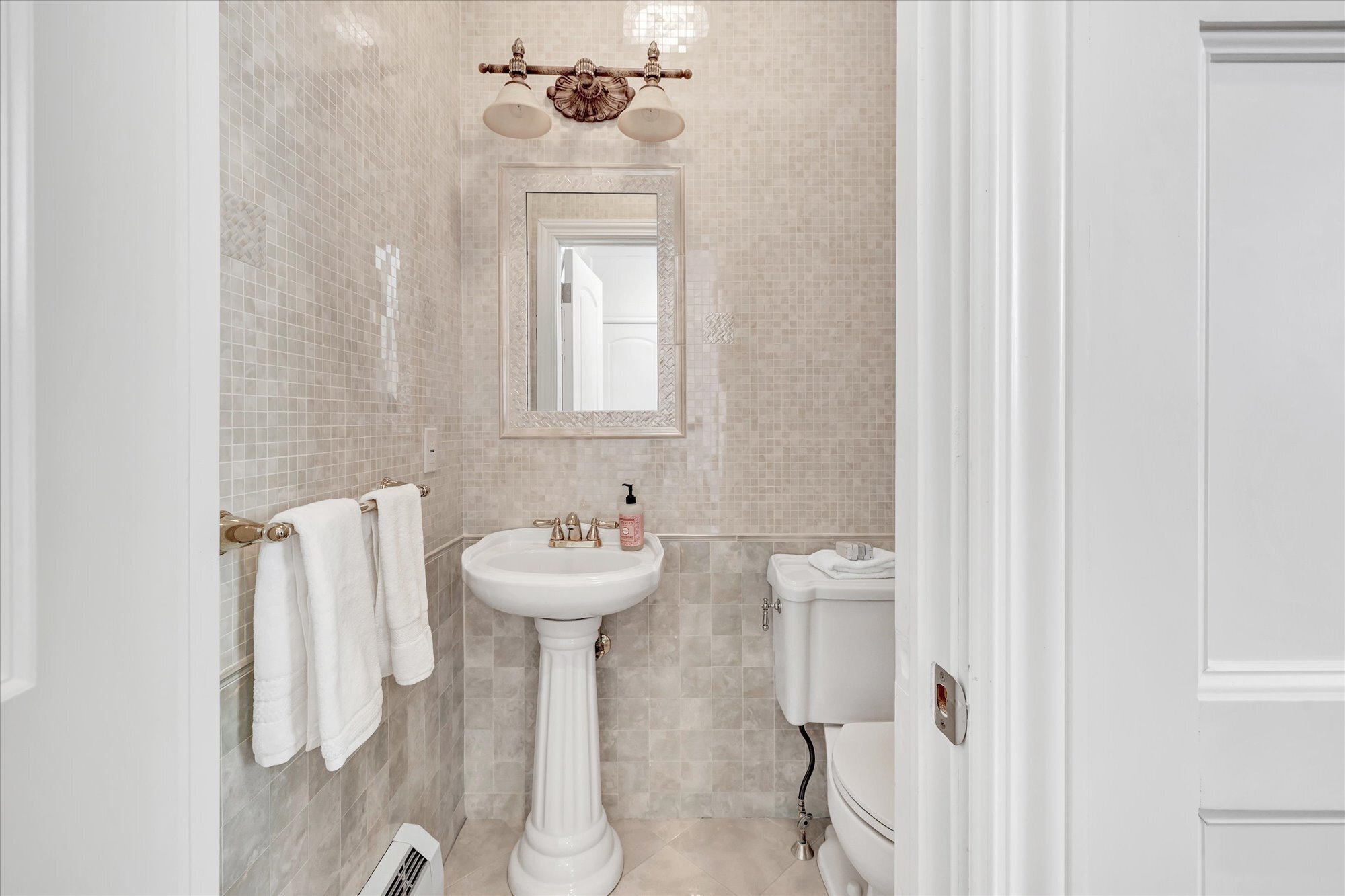 139 Jelliff Mill Road New Canaan, CT 06840 - Photo 13 of 40 a bathroom with a sink a toilet and mirror