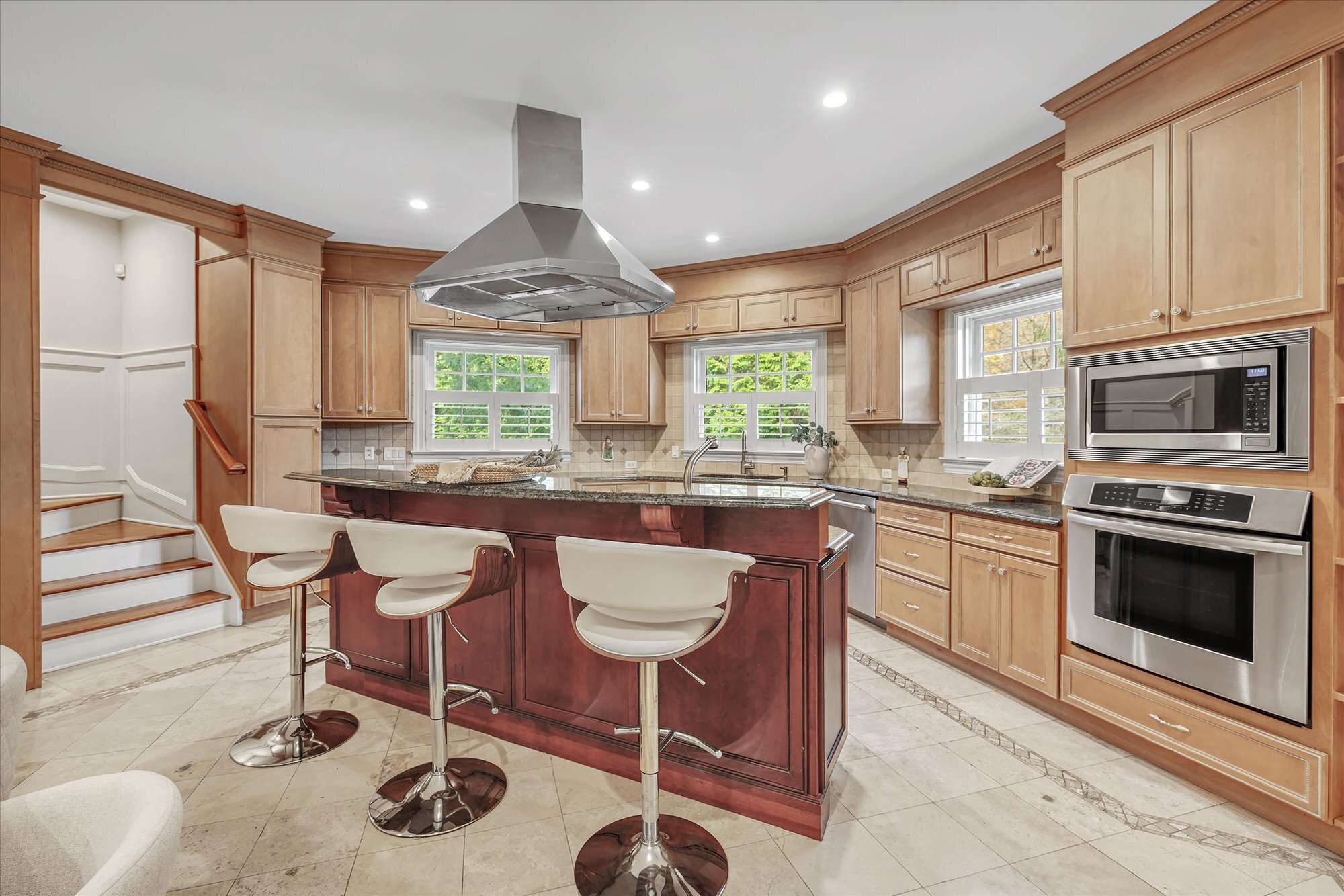 139 Jelliff Mill Road New Canaan, CT 06840 - Photo 19 of 40 a kitchen with stainless steel appliances granite countertop a stove a sink a microwave a dining table and chairs