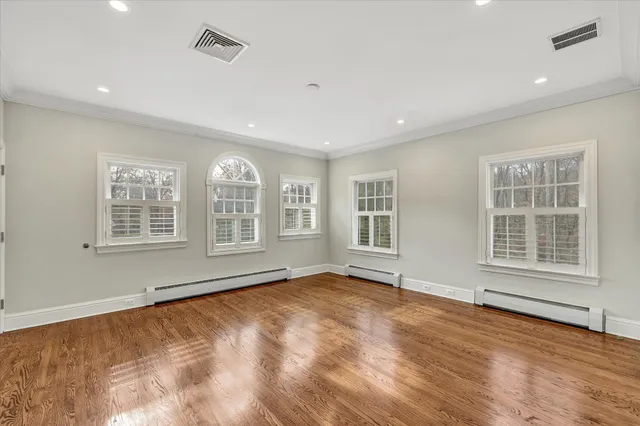 a spacious bathroom with a tub sink and mirror