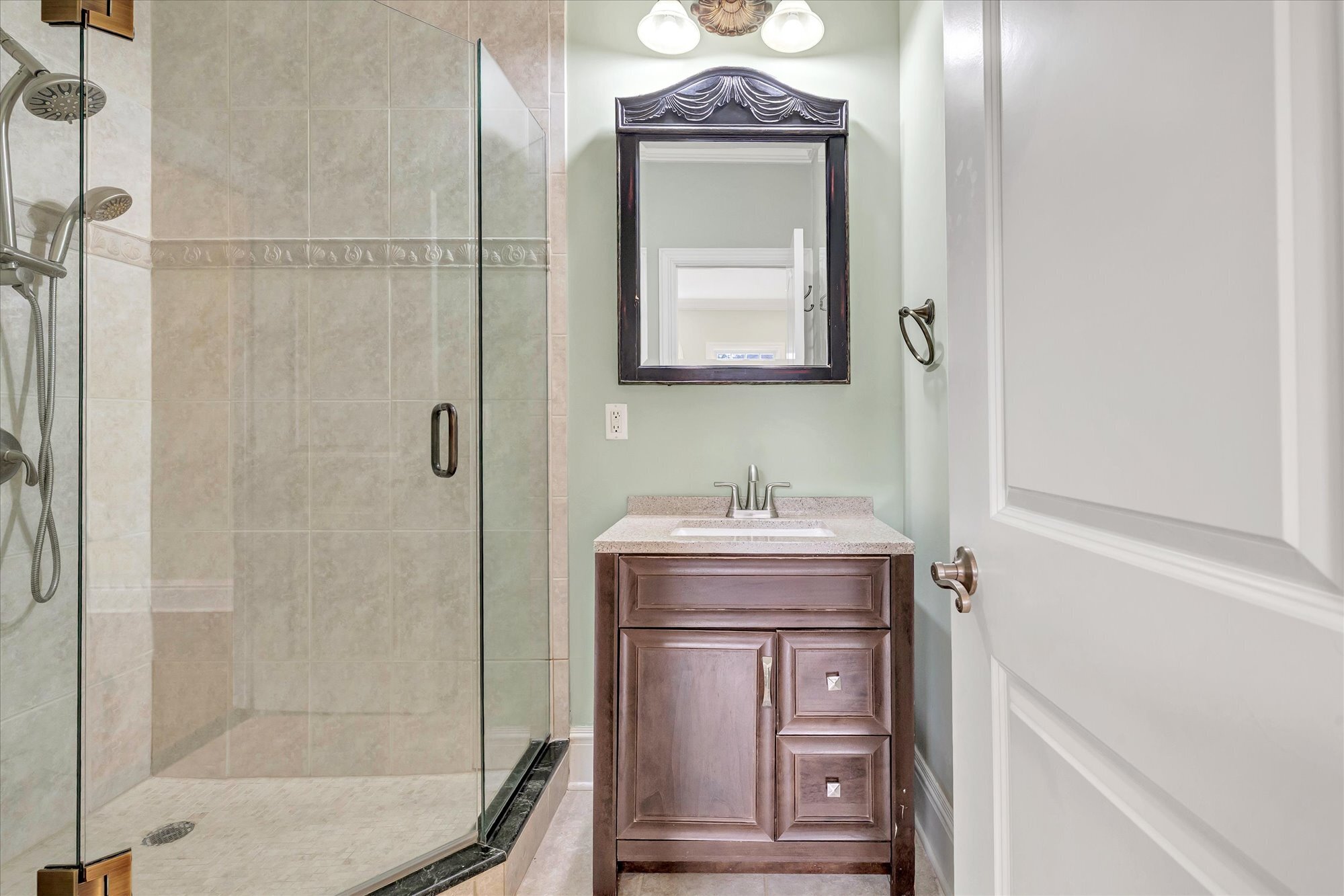 139 Jelliff Mill Road New Canaan, CT 06840 - Photo 30 of 40 a bathroom with a granite countertop sink a toilet a mirror and shower