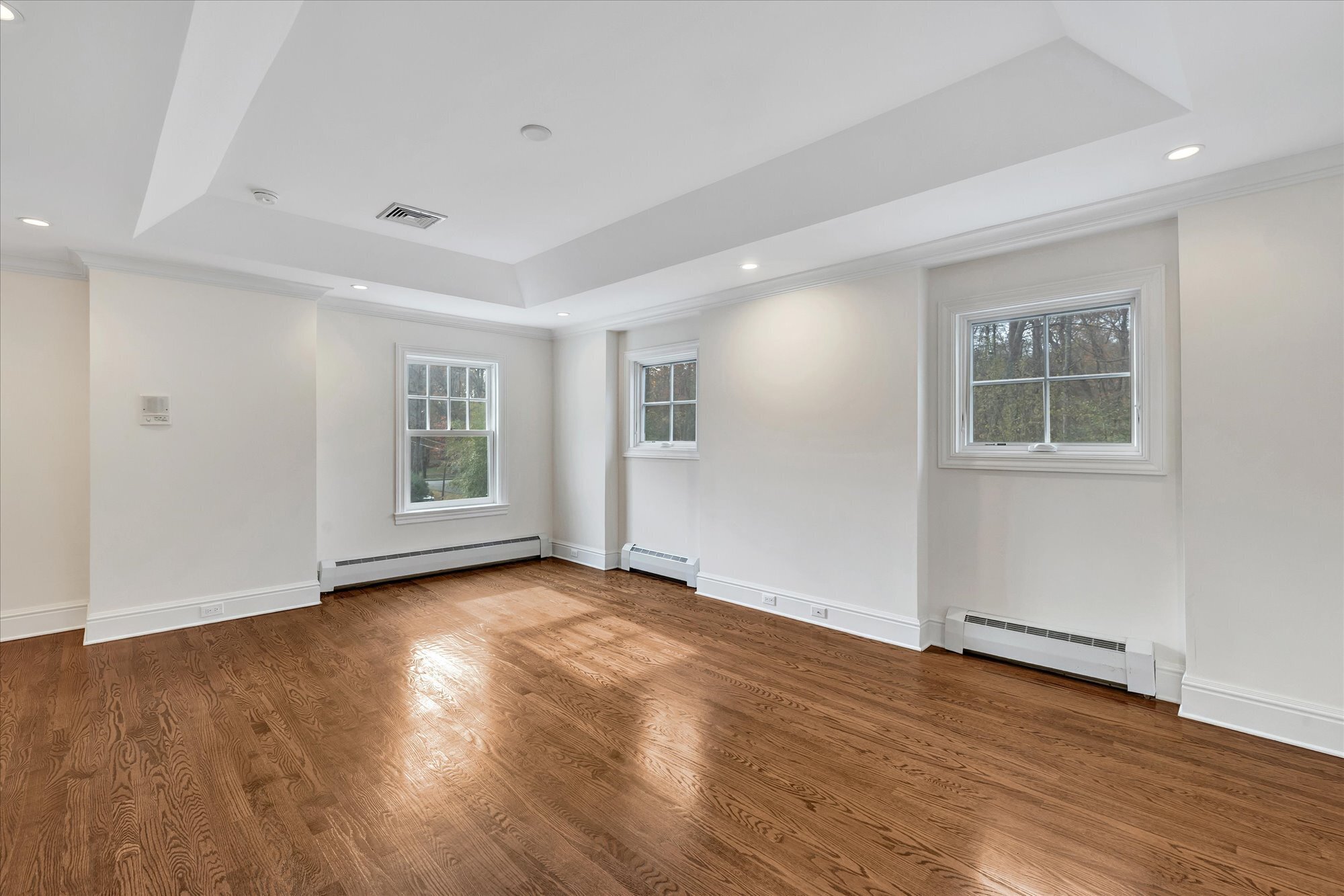 139 Jelliff Mill Road New Canaan, CT 06840 - Photo 31 of 40 a view of an empty room with wooden floor and a window