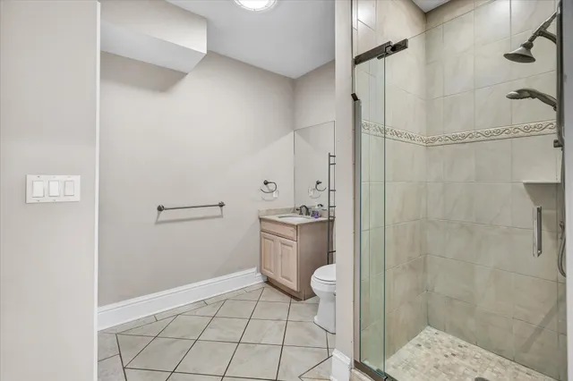 a open kitchen with stainless steel appliances a stove a sink and a refrigerator