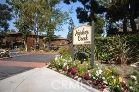 a sign that is sitting in front of flowers