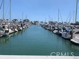 a view of water with boats and trees in the background