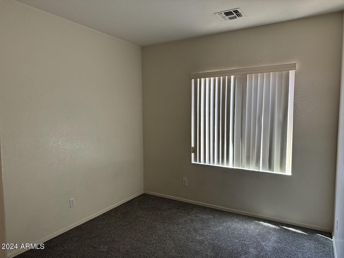 9401 West Berkeley Road Phoenix, AZ 85037 - Photo 18 of 27 an empty room with a window