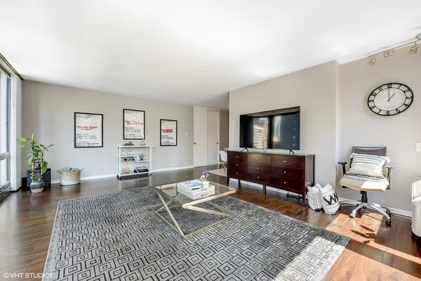 a living room with furniture a rug and a table