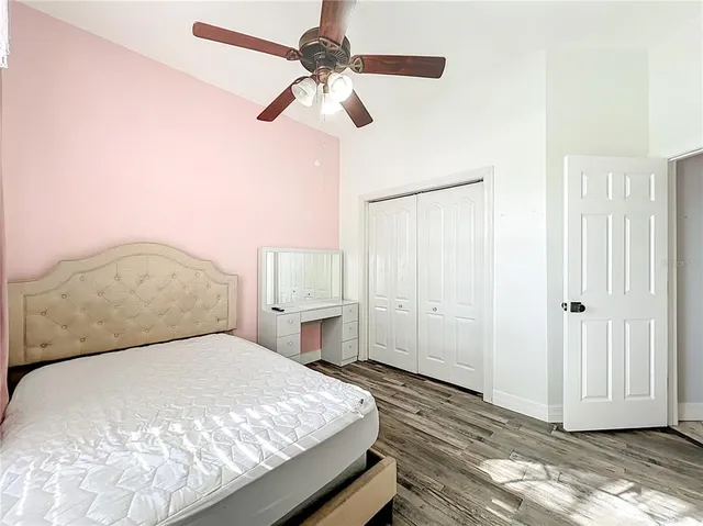 a bathroom with a granite countertop sink toilet mirror and shower