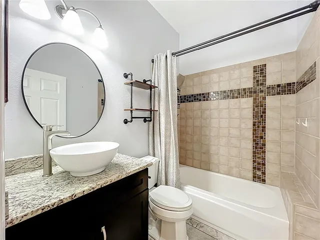 a view of a room with window and ceiling fan