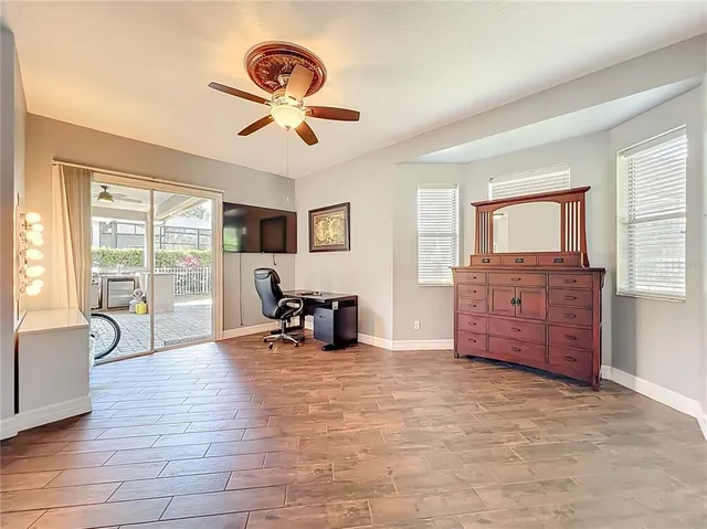 a view of a livingroom with furniture wooden floor and windows