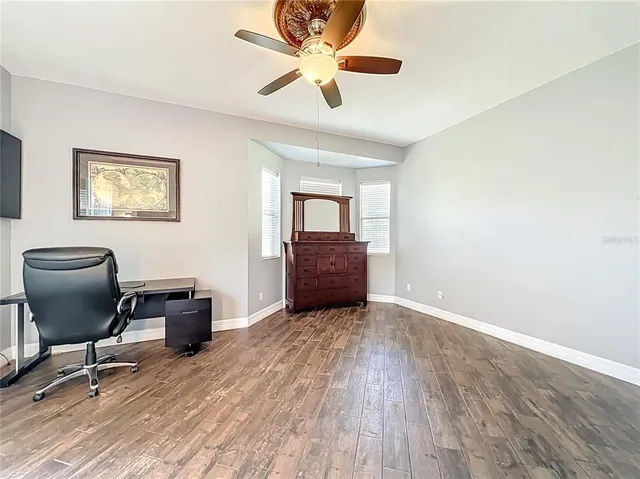 a spacious bathroom with a toilet sink and mirror