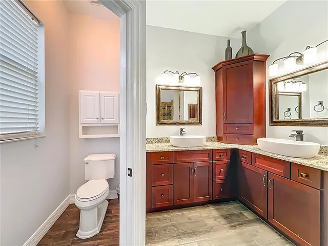a bathroom with a granite countertop sink mirror and shower