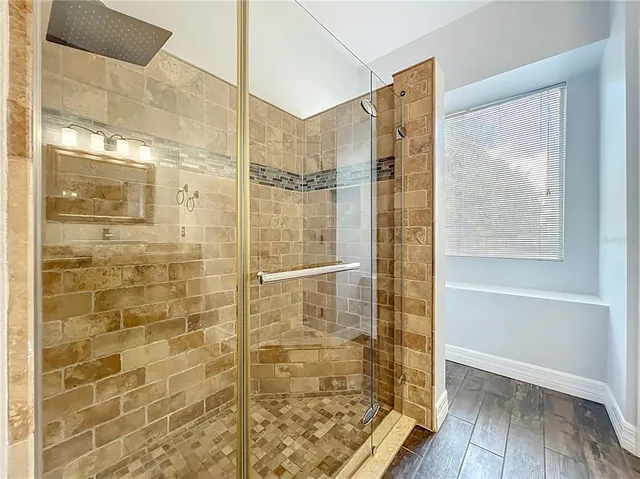 a view of closet with wooden floor