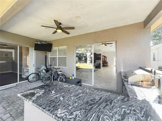 a kitchen with a stove and wooden cabinets