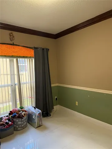 a room with a window and a projector screen